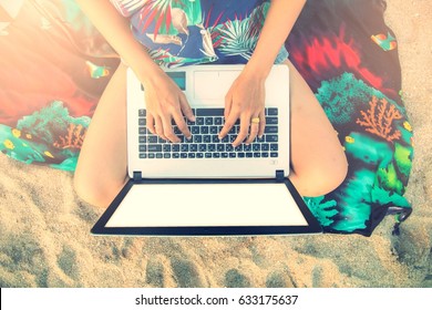 Beautiful Casual Woman With A Laptop On The Beach