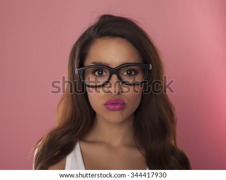 Beautiful casual woman over a pink background.