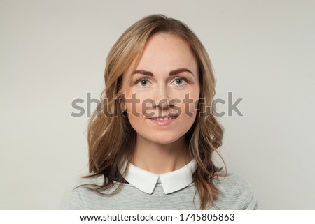 Beautiful casual woman smiling on white background, portrait