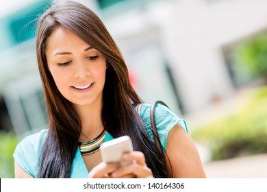 Beautiful Casual Woman Texting On Her Cell Phone