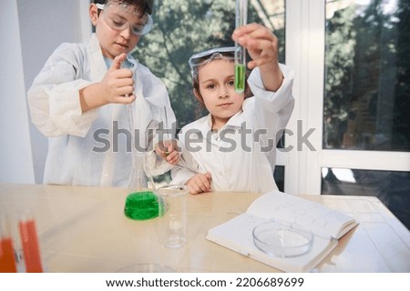 Similar – Image, Stock Photo Happy kid looking liquid through magnifying glass