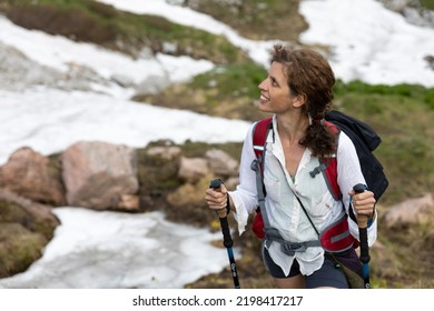 Beautiful Caucasian Curly Hair Woman Hiker Waist Up Portrait In Mountain Environment