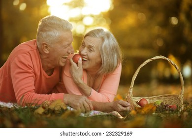 Beautiful caucasian elderly couple in the park in autumn - Powered by Shutterstock