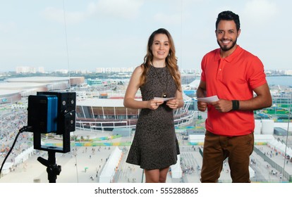 Beautiful Caucasian Female Presenter And Latin Man At Tv Studio