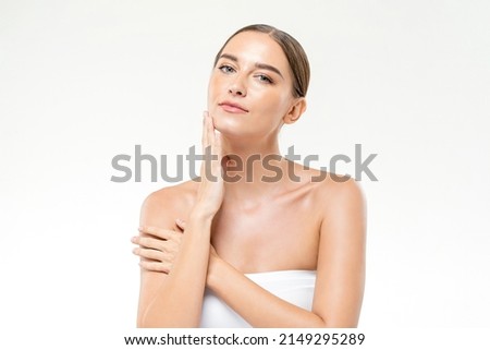 Beautiful Caucasian female with smooth skin touching face on clean isolated white background for skin care concepts