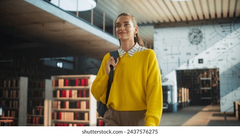 Beautiful Caucasian Female Student Walking in an Empty Public Library with Bookshelves. Young Smart Woman Carrying a Backpack with Textbooks to Prepare and Study for Exams. Low Angle Portrait - Powered by Shutterstock