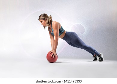 Beautiful Caucasian Fitness Model Wearing Long Fitness Outfit And Flower Patterned Sports Bra Doing A Balance Pushup On A Ball 