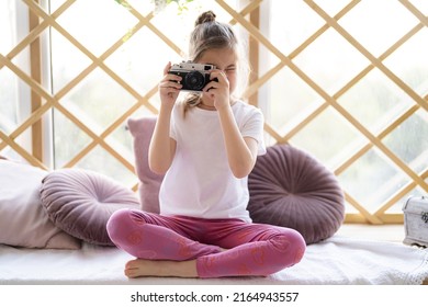 Beautiful Caucasian Kid Shoot Photograph From Her Film Camera At Home In Her Room. Vintage Filter Toned.