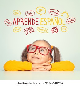 Beautiful caucasian little girl with eyeglasses looking at  Learn Spanish text in Spanish and illustrations. English: Learn English. Foreign language learning concept. - Shutterstock ID 2163448259
