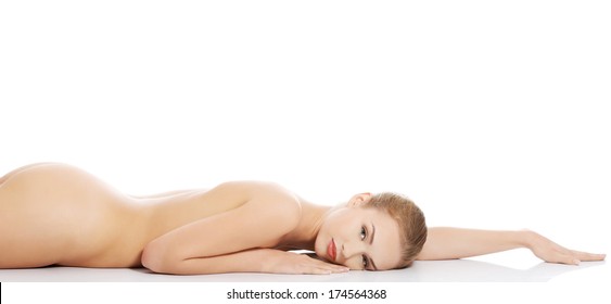 Beautiful caucasian naked woman lying down. Isolated on white.