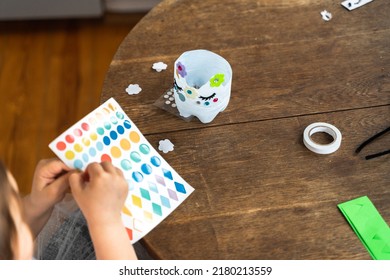 Beautiful Caucasian Preschool Girl Playing At Home And Doing Crafts From Plastic Bottle. Recycle Toys And Diy Creativity 