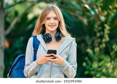 Beautiful Caucasian Student Teenager Smiling Happy Using Smartphone At The Park