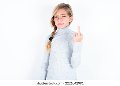 Beautiful Caucasian Teen Girl Wearing Gray Turtleneck Sweater Over White Wall  Shows Middle Finger Bad Sign Asks Not To Bother. Provocation And Rude Attitude.