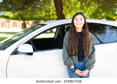 Beautiful Caucasian Teenager Girl Standing Next To Her First Car And Ready To Start Driving After Getting A Driver's License