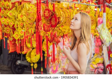Beautiful Caucasian tourist woman in Tet holidays. Vietnam Chinese Lunar New Year in springtime TEXT TRANSLATION from Vietnamese: Congratulations on the Vietnamese, Chinese New Years and wishes of all