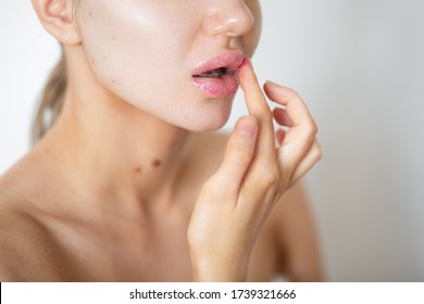 Beautiful Caucasian Woman Is Applying Scrub On Her Lips. Facial Skin Care. Puffy, Big Lips. Close-up.