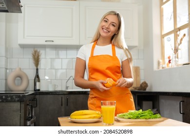 Beautiful Caucasian Woman In An Apron Cooking In The Kitchen	