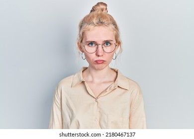 Beautiful caucasian woman with blond hair wearing casual look and glasses depressed and worry for distress, crying angry and afraid. sad expression. 