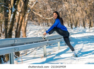 Beautiful Caucasian Woman Crouching And Adjusting Sneaker Before Running Outdoors.