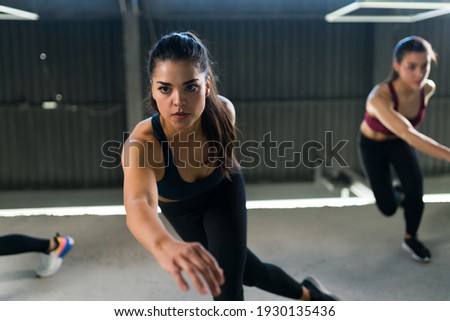 Similar – Image, Stock Photo Two fit women doing sports together, using a medicine ball to tone their body. Urban scene.