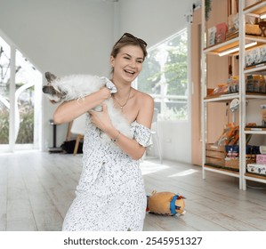 Beautiful caucasian woman playing with Yorkshire Terrier dog	 - Powered by Shutterstock