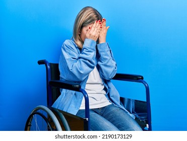 Beautiful caucasian woman sitting on wheelchair with sad expression covering face with hands while crying. depression concept.  - Powered by Shutterstock