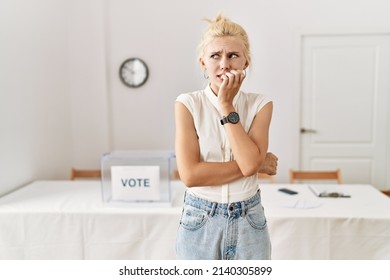 Beautiful Caucasian Woman Standing By Voting Ballot At Election Room Looking Stressed And Nervous With Hands On Mouth Biting Nails. Anxiety Problem. 