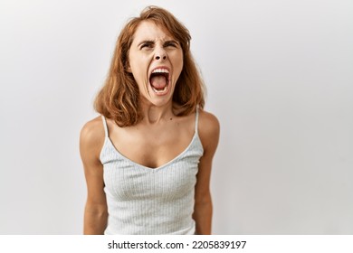 Beautiful caucasian woman standing over isolated background angry and mad screaming frustrated and furious, shouting with anger. rage and aggressive concept.  - Shutterstock ID 2205839197
