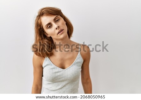 Beautiful caucasian woman standing over isolated background looking sleepy and tired, exhausted for fatigue and hangover, lazy eyes in the morning. 