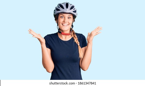 Beautiful caucasian woman wearing bike helmet celebrating crazy and amazed for success with arms raised and open eyes screaming excited. winner concept  - Powered by Shutterstock