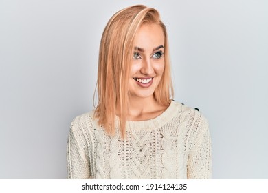 Beautiful Caucasian Woman Wearing Casual Winter Sweater Looking To Side, Relax Profile Pose With Natural Face And Confident Smile. 