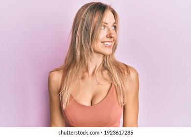 Beautiful caucasian woman wearing casual clothes looking to side, relax profile pose with natural face and confident smile. 