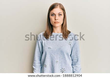 Beautiful caucasian woman wearing casual clothes with serious expression on face. simple and natural looking at the camera. 
