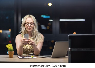 Beautiful Caucasian Woman Working Overtime In Office. Night Shift Worker. 