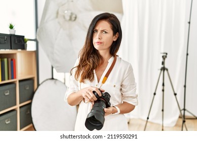 Beautiful Caucasian Woman Working As Photographer At Photography Studio Skeptic And Nervous, Frowning Upset Because Of Problem. Negative Person. 