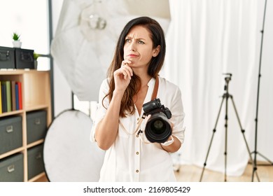 Beautiful Caucasian Woman Working As Photographer At Photography Studio Thinking Worried About A Question, Concerned And Nervous With Hand On Chin 