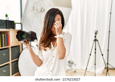 Beautiful Caucasian Woman Working As Photographer At Photography Studio Tired Rubbing Nose And Eyes Feeling Fatigue And Headache. Stress And Frustration Concept. 