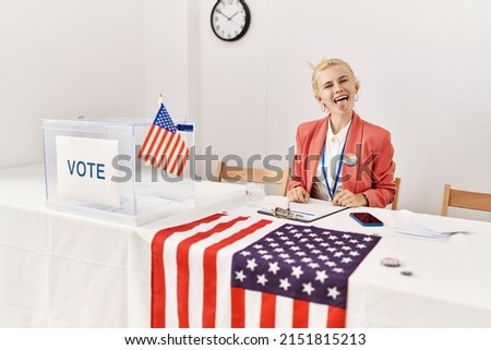 Beautiful caucasian woman working at political campaign sticking tongue out happy with funny expression. emotion concept. 