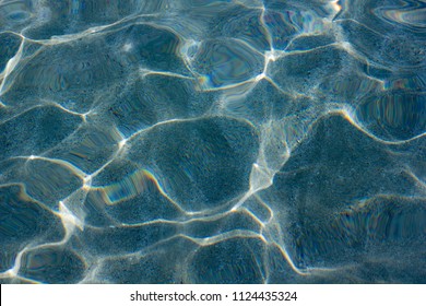 Beautiful caustics on water surface in blue sea