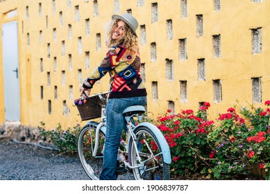 Beautiful And Cheerful Active Young Adult Caucasian Woman Ready To Go On Bike Bycicle Ride Activity At Home In The Garden - Pretty Female Smile And Have Fun In Outdoor Leisure Activity