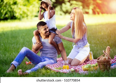 Beautiful Cheerful Family Outdoors Enjoying Picnic Outing