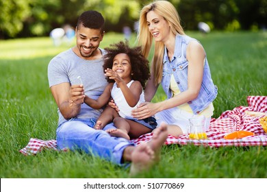 Beautiful Cheerful Family Outdoors Enjoying Picnic Outing