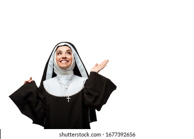 beautiful cheerful nun looking up with shrug gesture, isolated on white