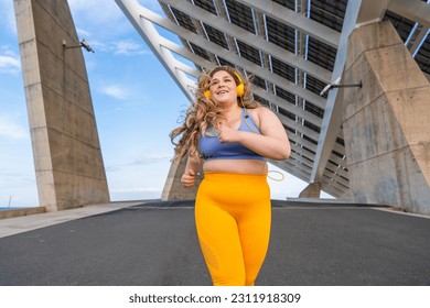 Beautiful and cheerful plus size young woman outdoors - Pretty overweight curvy female, concepts about femininity, women power, female emancipation, body positivity and body acceptance - Powered by Shutterstock