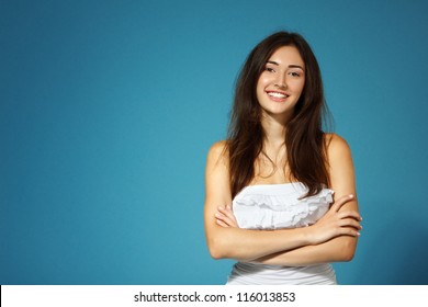 Beautiful Cheerful Teen Girl In White Top Over Blue Background