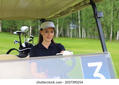 Beautiful cheerful woman driving golf cart
