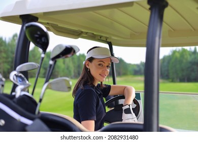 Beautiful cheerful woman driving golf cart