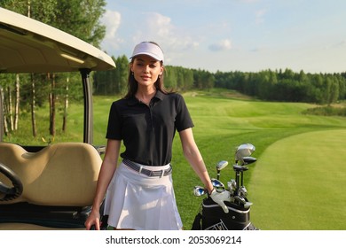 Beautiful cheerful woman standing near in golf cart