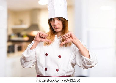 Beautiful Chef Woman Making Bad Signal In The Kitchen