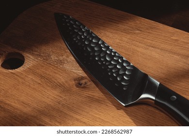 A beautiful chef's knife on a wooden background - Powered by Shutterstock